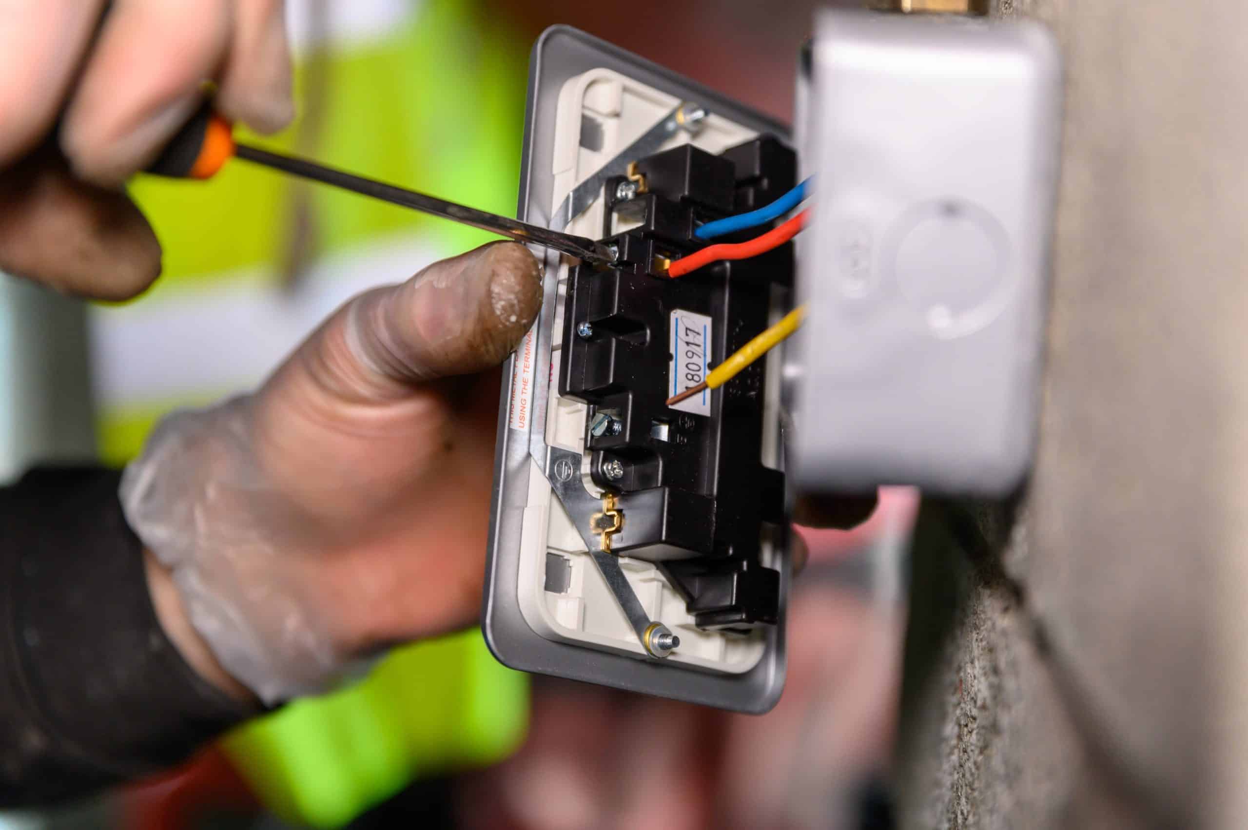 Technician checking the GFCI outlet in a garage