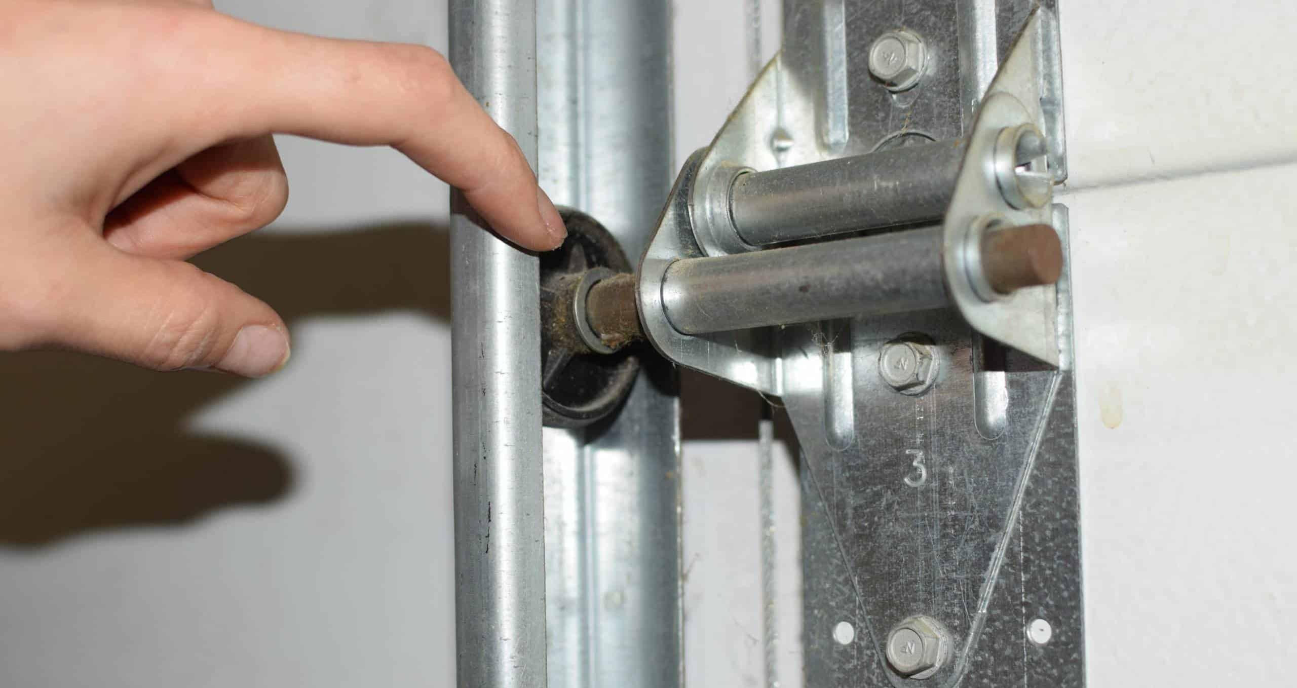 Finger Pointing at Garage Door Rollers.jpg 11818 Scaled 1