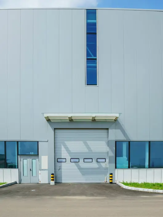 High-Speed Commercial Glass Garage Doors Operating at Logistics Center