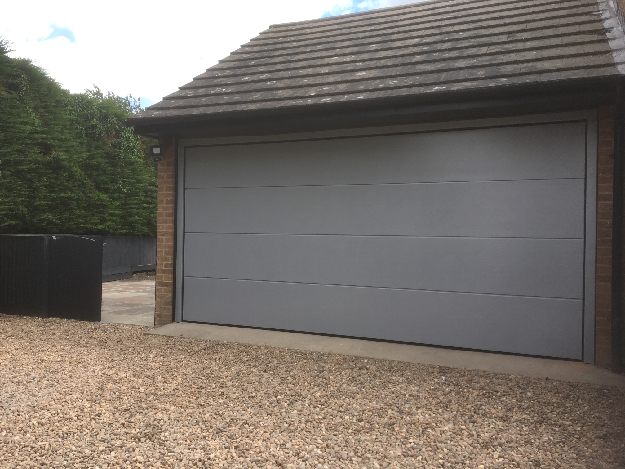 Action shot professional garage door installer insulated sectional door