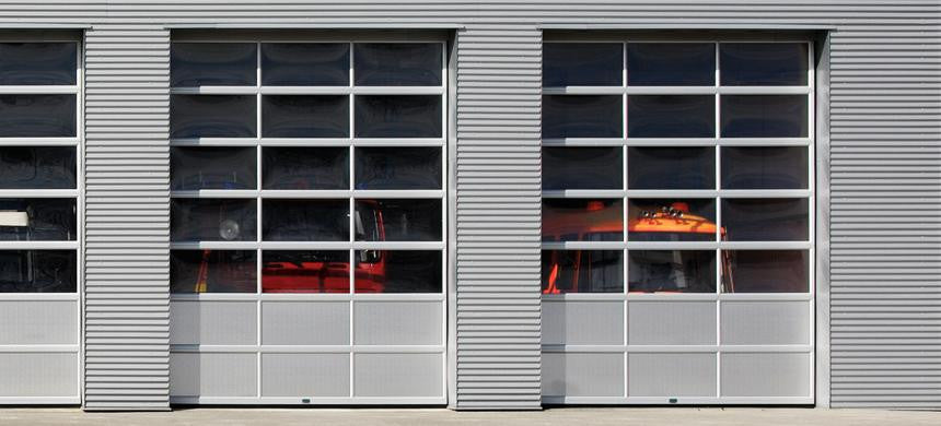 Business Owner Inspecting Commercial Glass Garage Door