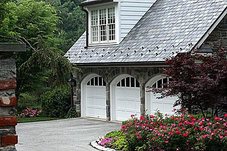 Create a highly detailed image of design sketches or blueprints for modern adaptations of carriage garages.