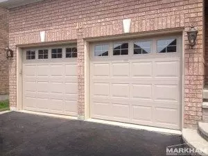 homeowner looking frustrated at a frozen garage door