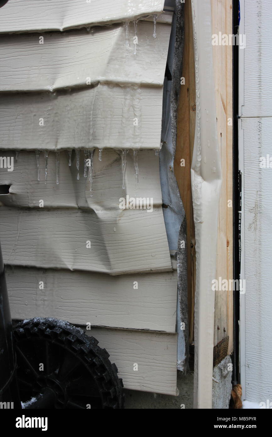 Bent and dented garage door jamb due to a car accident