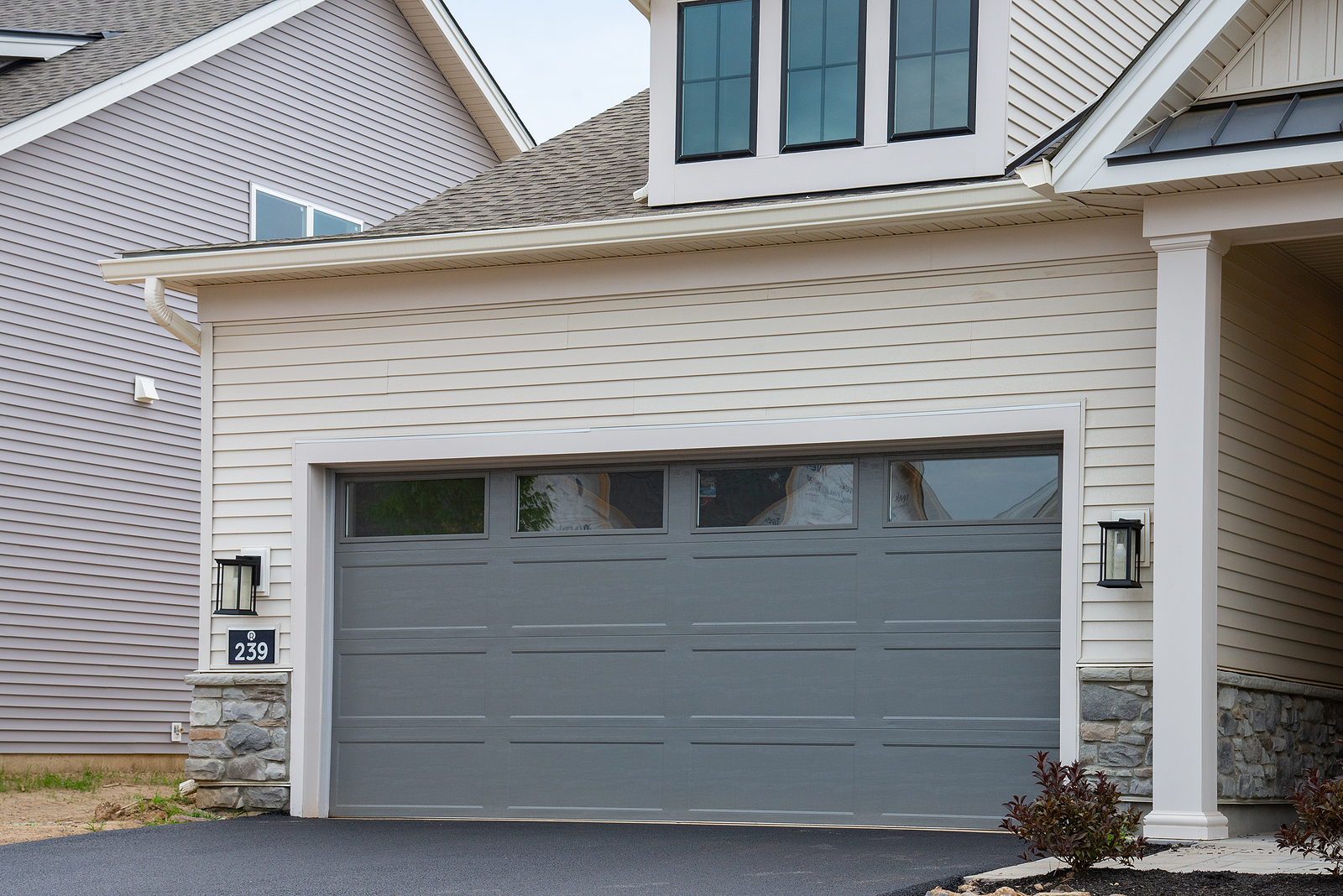 Family working together replacing garage door panel sunny weekend teamwork photo