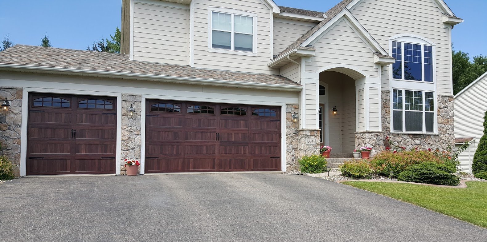 Technician repairing garage door in rain