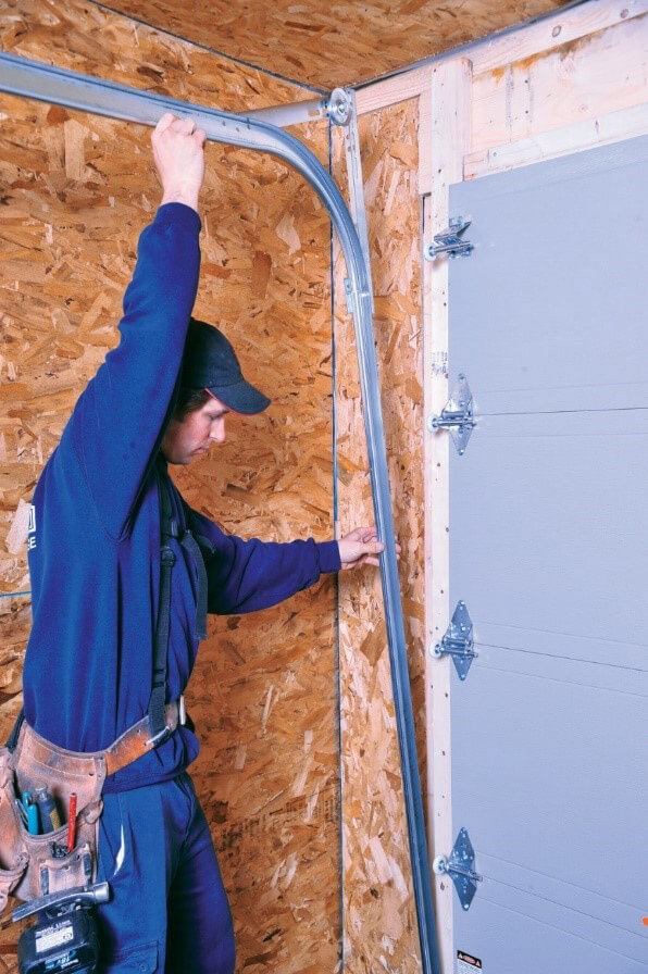 Professional Technician Installing Flush Garage Door