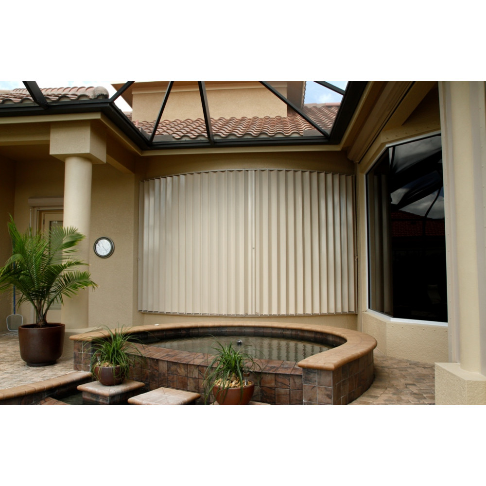 Comparison photo showcasing a house before and after storm shutter installation.
