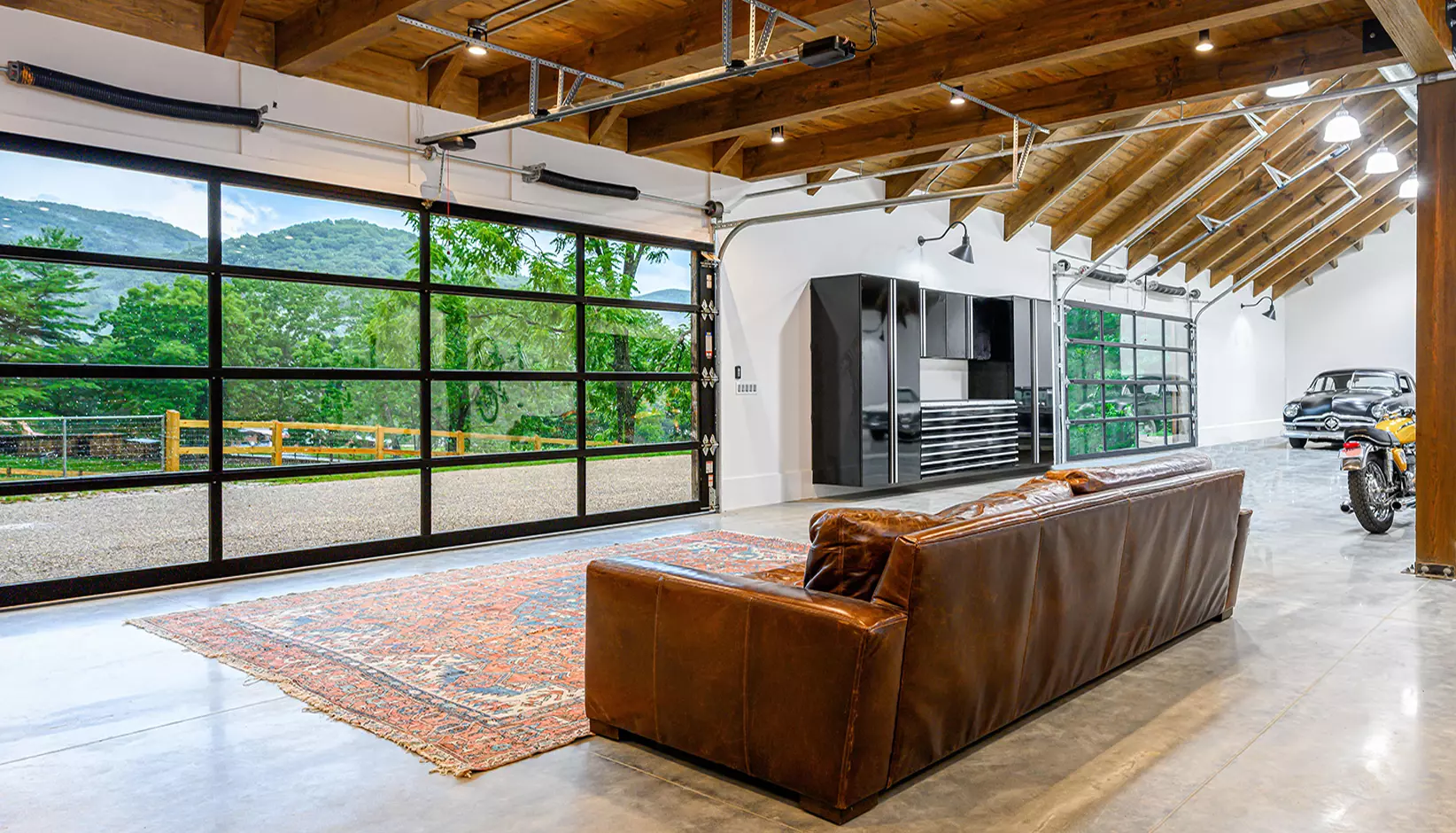 Modern living room sliding glass garage door open backyard