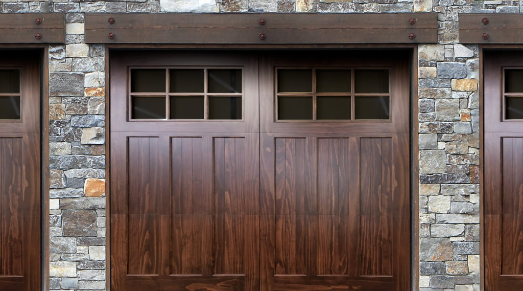 Joyful Family Standing in Front of New Wooden Garage Door
